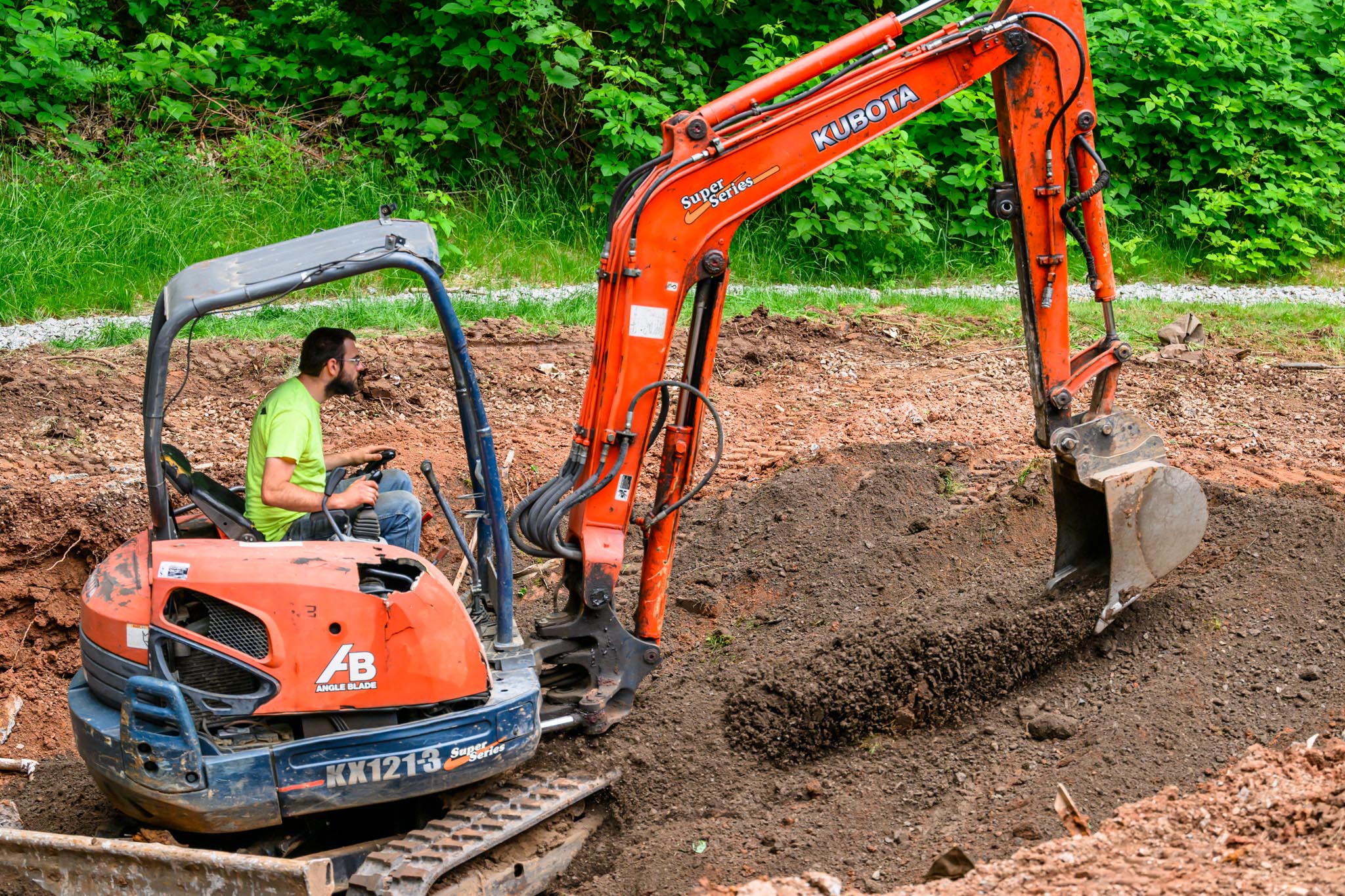 Starting the topsoil process to elevate backyard transformation.