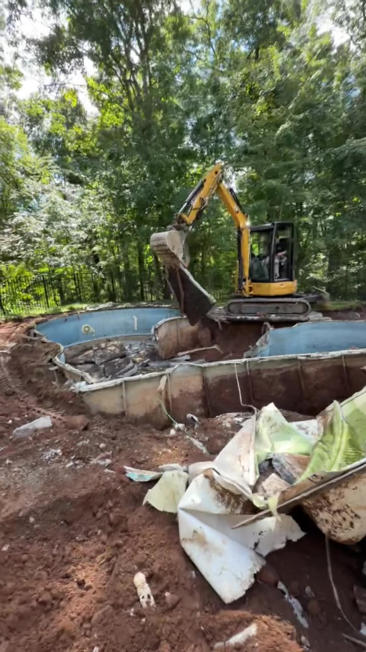 Excavator dismantling the pool structure during removal in Guilford, CT